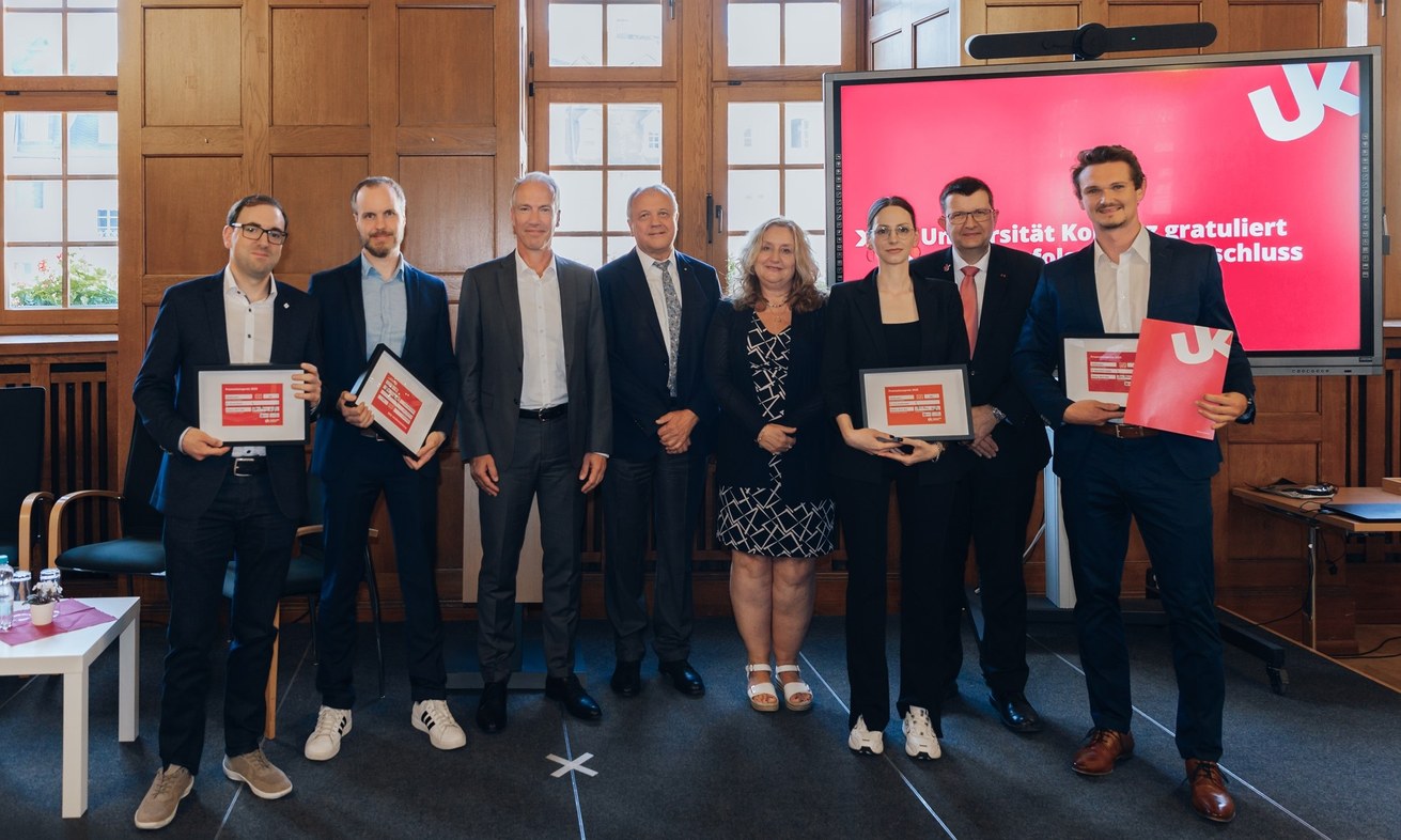 Die Preisträger*innen des Promotionspreises 2025 der Universität Koblenz v.l.n.r.: Dr. Dennis Peuter (li.), Dr. Andreas Sieß (2.v.l.), Dr. Viola Dombrowski (3.v.r.) und Dr. Maximilian Gießler (re.). Neben Universitätspräsident Prof. Dr. Stefan Wehner (2.v.r.) und Vizepräsidentin Prof. Dr. Claudia Quaiser-Pohl (4.v.r.) gratulierten auch Werner Höffling (4.v.l.) und Tim Schwarzburg (3.v.l.) vom Freundeskreis der Universität in Koblenz e. V..  Bild: Teresa Schardt